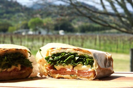 Gourmet sandwich for a picnic at Amista Vineyards, shown in the background